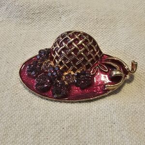 Red and purple costume hat with purple floral gold plated brooch